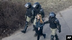FILE - Police officers detain a demonstrator as they prevent an opposition action to protest the official presidential election results in Minsk, Belarus, March 27, 2021.