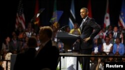 U.S. President Barack Obama playfully mimics the arms-akimbo stance of a young woman who asked a question during a town hall session at the Young African Leaders Initiative (YALI) Mandela Washington Fellowship Presidential Summit in Washington, Aug. 3, 20