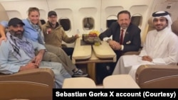 امیر امیري، چې توره پیک داره خولۍ یې په سر ده، د طالبانو له زندان څخه تر خوشې کېدو وروسته کور ته په لار دی.