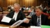 Oscar Pistorius's lawyers Barry Roux (L) and Brian Webber prepare documents before the start of the application to appeal some of his bail conditions at a Pretoria court in Pretoria, March 28, 2013. 