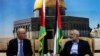Senior Hamas leader Ismail Haniyeh (R) speaks with Palestinian Prime Minister Rami Hamdallah at Haniyeh's house in Gaza City, Oct. 9, 2014. 