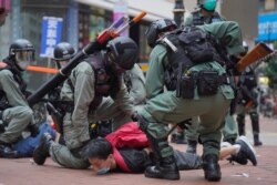 Riot police detain a protester during a demonstration against Beijing's national security legislation in Causeway Bay in Hong Kong, May 24, 2020.