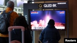 FILE - People watch a TV broadcasting a news report on North Korea firing a ballistic missile into the sea off its east coast, at a railway station in Seoul, South Korea, March 16, 2023. 