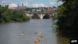 People kayak on the Potomac River near the Georgetown neighborhood and Theodore Roosevelt Island in Washington,