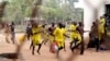 FILE - Prisoners runs towards their ward after their prison riot was quelled at the Lira Central Prison in Northern Uganda, Feb. 13, 2013. 