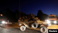 An armored vehicle escorts a Turkish military convoy in the border town of Akcakale in Sanliurfa province, Turkey, October 12, 2019. REUTERS/Murad Sezer