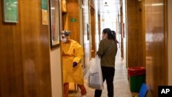 Health technician Marina Parrilla, 31, left, welcomes coronavirus patient Maribel Soliz at a hotel in Leganes, outskirts of Madrid, Spain, Thursday, Oct. 15, 2020. The NH Leganes is one of the hotels run by health professionals to quarantine COVID…