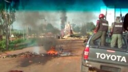 FILE - A bonfire and overturned vehicles block the road as police attempt to restore calm in the town of Jos, Nigeria, June 25, 2018, after deadly clashes between mostly Muslim herders and Christian farmers. (Nigeria Government via AP)