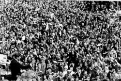 FILE - U.S. President John F. Kennedy, left, waves to a crowd of more than 300,000 gathered to hear him declare "Ich bin ein Berliner," "I am a Berliner," in front of Schoeneberg City Hall, West Berlin, June 26, 1963.