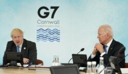U.S. President Joe Biden and Britain's Prime Minister Boris Johnson attend a session during the G7 summit in Carbis Bay, Cornwall, Britain, June 11, 2021.