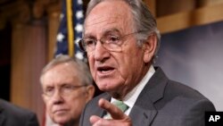 Senator Tom Harkin, sponsor of the Minimum Wage Fairness Act (R), joined by Senate Majority Leader Harry Reid, comments to reporters after the bill to raise the minimum wage to $10.10 was stopped in the Senate, during a news conference on Capitol Hill in 