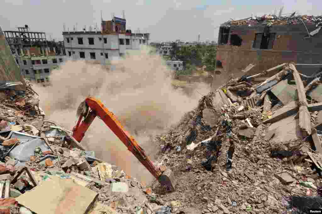 The remaining standing part of the collapsed Rana Plaza building collapses during a rescue operation by the army in Savar, Bangladesh, May 2, 2013. 
