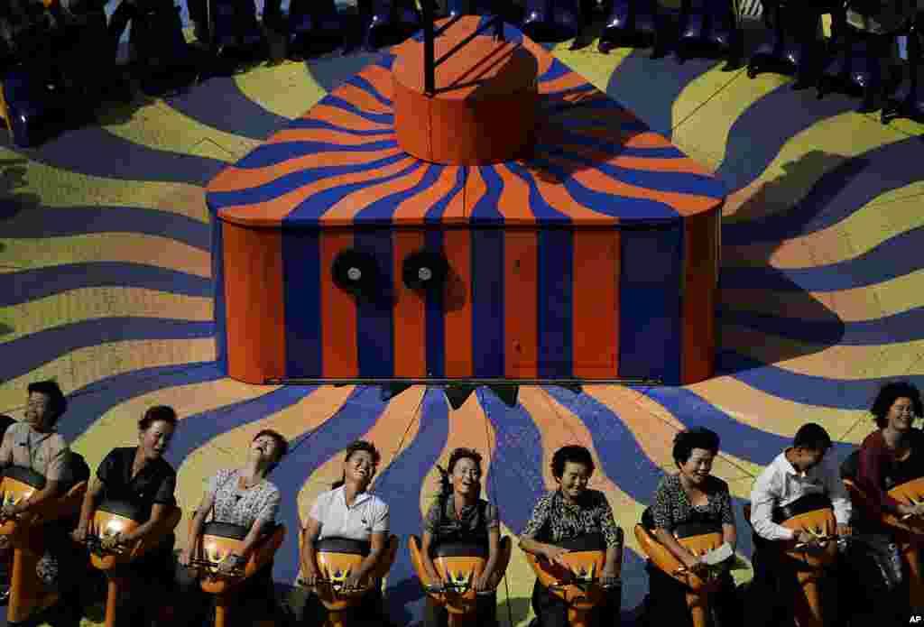 North Koreans enjoy a ride at the Kaeson Youth Amusement Park in Pyongyang.