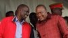 Kenyan President Uhuru Kenyatta (right) talks with Vice President William Ruto during the unveiling of a cargo train at the Mombasa, Kenya, port containers depot, May 30, 2017.