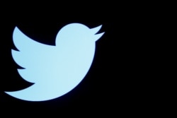 FILE - The Twitter logo is displayed on a screen on the floor of the New York Stock Exchange (NYSE) in New York City.