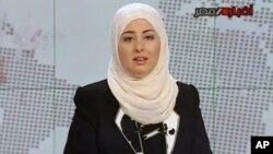 Egypt State TV, Fatma Nabil reads out the headlines wearing a headscarf on the noon news bulletin on state television in Cairo, Egypt, Sept. 3, 2012.