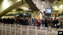 Commuters leave a train at the Montparnasse train station, Dec.17, 2019 in Paris on the 13th straight day of traffic headaches. 