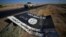 A black sign belonging to Islamic State militants is seen on the road in Al-Al-Fateha military airport south of Hawija, Iraq, Oct. 2, 2017.