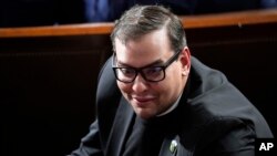 FILE - U.S. Representative George Santos, a Republican from New York, watches on the House floor at the Capitol in Washington on Oct. 25, 2023.