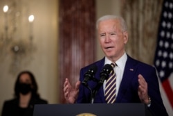 FILE - U.S. President Joe Biden delivers a foreign policy address as Vice President Kamala Harris listens, at the State Department in Washington, Feb. 4, 2021.