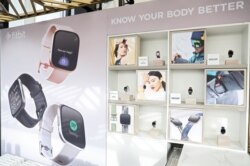 FILE - Fitbit devices and software include Fitbit Premium, various sleep tools, Fitbit Versa 2 smartwatch with Amazon Alexa Built-in, and its Aria Air smart scale, Aug. 27, 2019.