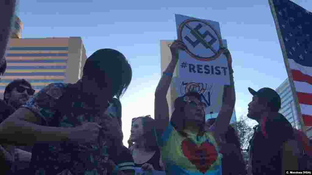Arizonans dance and chant as they protest President Donald Trump's visit to Phoenix, Aug. 22, 2017.