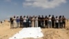 Mourners pray next to the bodies of Palestinians killed in Israeli strikes due to an Israeli military operation in Rafah, amid the ongoing conflict between Israel and Hamas, in Khan Younis, in the southern Gaza Strip, June 19, 2024. 