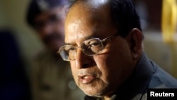 R.K.Gupta, a doctor who performed sterilization surgeries at a government mass sterilization "camp," sits at a police station in Bilaspur, in the eastern Indian state of Chhattisgarh, Nov. 13, 2014.