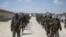 FILE - Members of Somalia's al-Shabab militant group march on the outskirts of Mogadishu, Somalia, March, 5, 2012. 