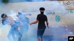 Iraqi security forces fire tear gas during ongoing anti-government protests in Basra, Iraq, Nov. 8, 2019.