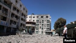 A Palestinian man views the damage to the health ministry headquarters in the aftermath of Israeli air strikes, in Gaza City May 19, 2021.
