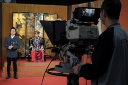 Ng Chi-sam, right, and Tsang Chi-ho, hosts of RTHK's satirical comedy show "Headliner," perform the show, in Hong Kong, China, June 5, 2020.