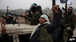 Turkish-backed Syrian fighters are pictured in the back of their trucks as they leave their barracks in the rebel-held border town of Jarabulus on December 25, 2018, as they prepare to move towards Manbij.