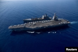 FILE - The world's largest aircraft carrier USS Gerald R. Ford steams alongside USNS Laramie (T-AO-203), taken on October, 11, 2023 and released by U.S. Navy on October 14, 2023. (U.S Naval Forces Central Command / U.S. 6th Fleet / Handout via REUTERS/File Photo)