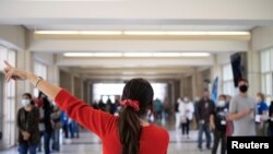 Volunteers are instructed at a coronavirus vaccine clinic run by Skippack Pharmacy in Lansdale, Pennsylvania, April 18, 2021. 