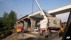 FILE - Construction work is in progress at a new international trade route which part of a sprawling Chinese initiative to build a "new Silk Road" of ports, railways, and roads to expand trade in a vast arc of countries across Asia, Africa and Europe, near Havalian Pakistan, May 11, 2017.