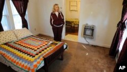 Charlene Presley, a relative by marriage to Elvis Presley, stands in a house said to be a boyhood home of the singer in Tupelo, Miss., Oct. 17, 2017. 