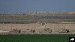 Israeli army APCs are moving along the border with the Gaza Strip in southern Israel, Jan. 16, 2025. 