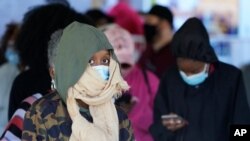 FILE - Voters brave a chilly and windy morning to cast their ballots early Friday, Oct. 30, 2020, in Covington, Ga.