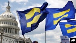ARSIP – Peserta Kampanye HAM mengibarkan “bendera kesetaraan” selama penyelenggaraan rapat akbar di Capitol Hill di Washington guna mendukung kaum transgender dalam dinas militer (foto: AP Photo/Jacquelyn Martin)