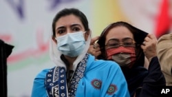 Aseefa Bhutto Zardari, left, a leader of the Pakistan Democratic Movement, an alliance of opposition parties, attends an anti-government rally, in Multan, Pakistan, Monday, Nov. 30, 2020. 