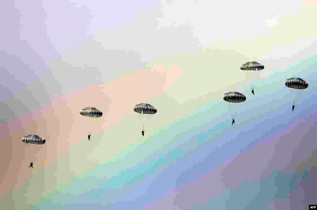 Russian paratroopers jump as a rainbow appears in the sky during the joint Russian, Belarusian and Serbian military exercise &quot;The Slavic Brotherhood&quot; at the military ground Kovin, near Belgrade.