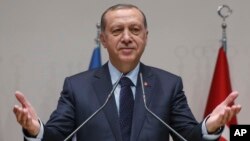 Turkey's President Recep Tayyip Erdogan, gestures as he delivers a speech during a ceremony to rejoin the ruling Justice and Development Party, or AKP, in Ankara, Turkey, May 2, 2017. 