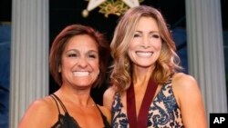 FILE - Oklahoma Hall of Fame inductee Shannon Miller, right, stands with her presenter, Mary Lou Retton, in Oklahoma City on Nov. 16, 2017. Retton. 55, is in intensive care in a Texas hospital fighting a rare form of pneumonia, according to her daughter McKenna Kelley.