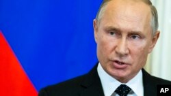 Russian President Vladimir Putin speaks to the media during a joint news conference with Hungarian Prime Minister Viktor Orban after their talks in the Kremlin in Moscow, Sept. 18, 2018. 