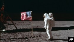 FILE - Astronaut Buzz Aldrin Jr. is captured in a photograph beside a U.S. flag on the moon during the Apollo 11 mission. Aldrin and fellow astronaut Neil Armstrong were the first men to walk on the lunar surface. Astronaut Michael Collins flew the command module.