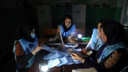 Afghan election workers count ballots in the presidential elections at a polling station in Kabul, Afghanistan, Sept. 28, 2019. An unofficial estimate put voter turnout at a little more than 2 million voters out of nearly 10 million.