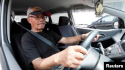 Yorie Miho drives his minicar as he leaves a minicar dealership in Yamato, Kanagawa Prefecture, Japan August 11, 2018. (REUTERS/Kim Kyung-Hoon)