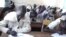South Sudanese children sit for a high school exam in Aweil on March 20, 2013. The first ever national high school exams offered in the country have been marred by a shortage of test papers and poorly set questions. (VOA/Hou Akot Hou)