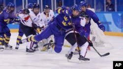 2018 평창동계올림픽 남북한 여자아이스하키 단일팀이 마지막 경기를 치룬 20일 스웨덴 선수와 한국 선수가 공을 다투고 있다.